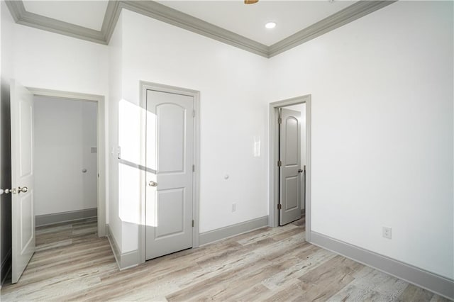 unfurnished bedroom with crown molding and light hardwood / wood-style flooring