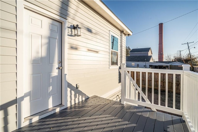 view of exterior entry with a wooden deck