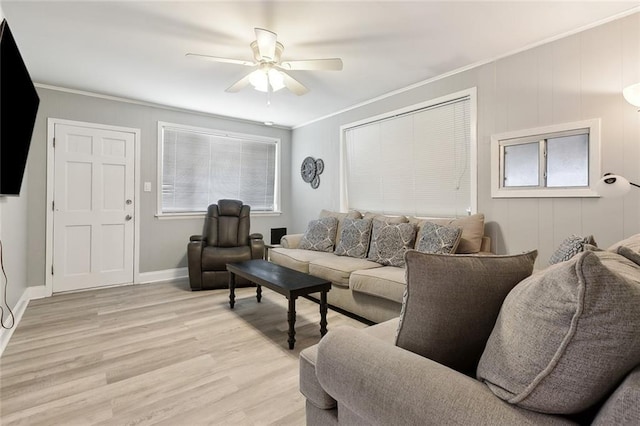 living room with ceiling fan, ornamental molding, and light wood-type flooring