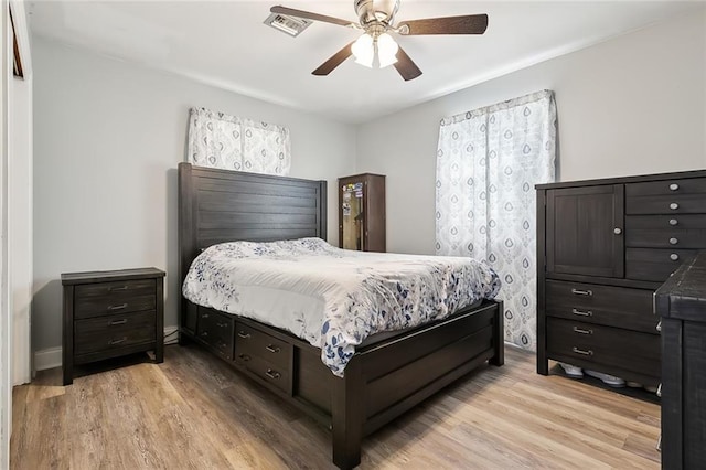 bedroom with light hardwood / wood-style flooring and ceiling fan