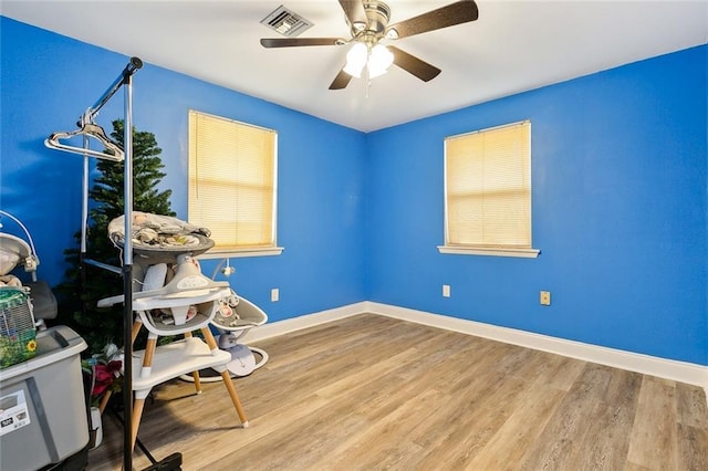 interior space with wood-type flooring and ceiling fan