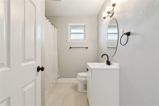 bathroom with vanity, tile patterned floors, and toilet