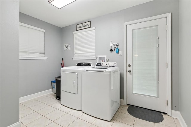 laundry room featuring washer and dryer and light tile patterned floors