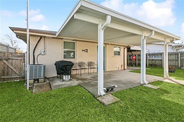 back of property featuring a patio area, central air condition unit, and a lawn