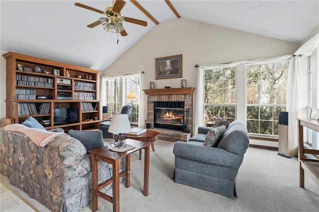 living room featuring light carpet, a fireplace, high vaulted ceiling, and ceiling fan