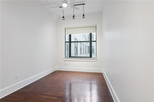 empty room featuring ceiling fan and dark hardwood / wood-style flooring