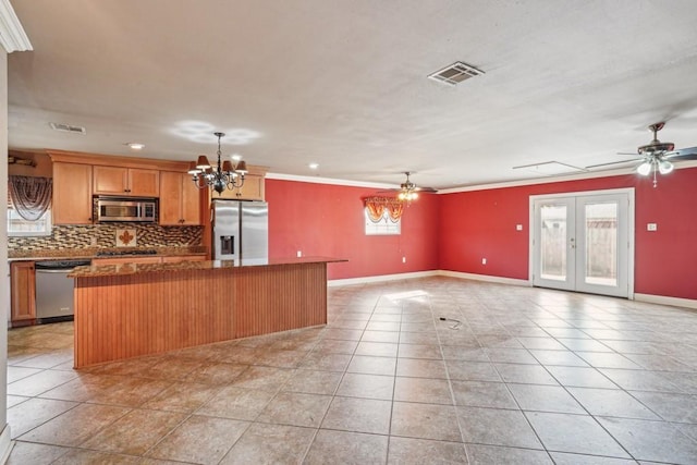 kitchen with tasteful backsplash, visible vents, a center island, stainless steel appliances, and french doors