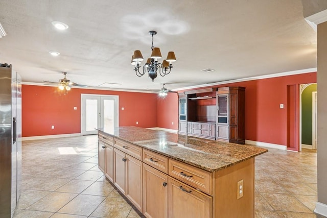 kitchen with arched walkways, french doors, ornamental molding, stainless steel fridge, and ceiling fan with notable chandelier