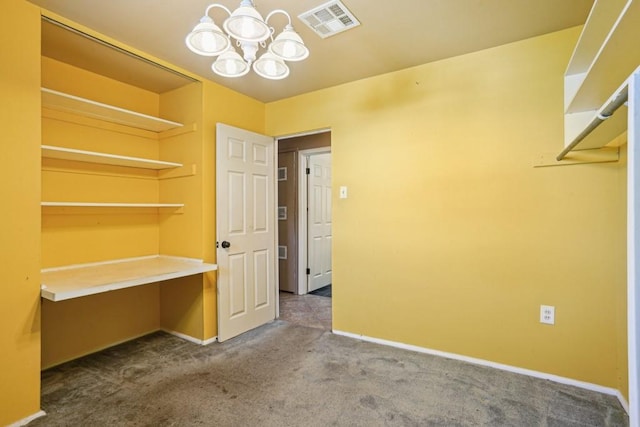 interior space featuring an inviting chandelier, visible vents, and carpet flooring