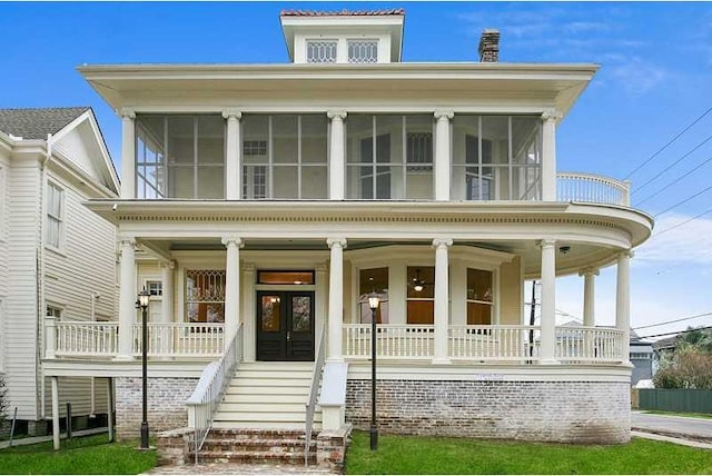 view of front of home featuring french doors and covered porch