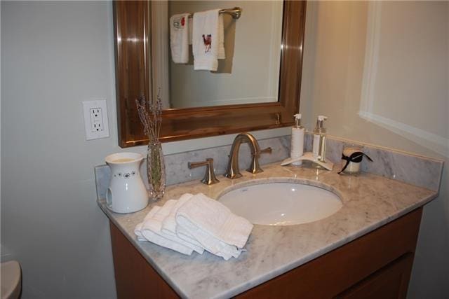 bathroom featuring vanity and toilet