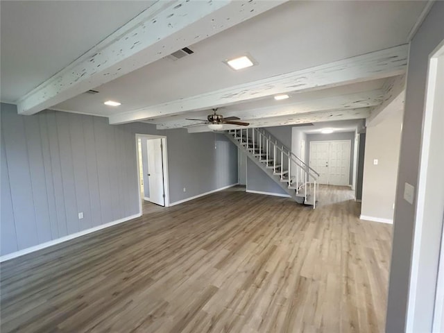 basement with hardwood / wood-style flooring and ceiling fan