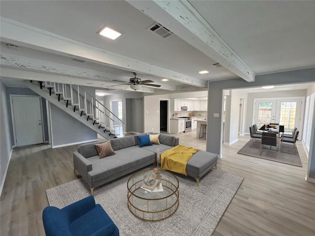 living room with ceiling fan, hardwood / wood-style floors, and beam ceiling