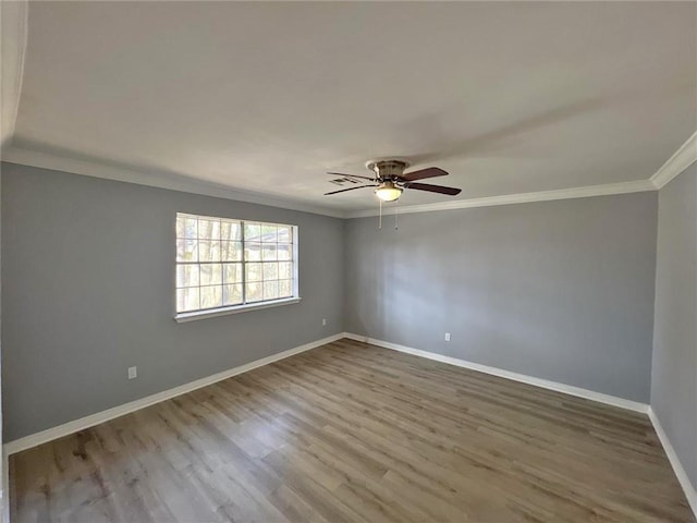 empty room featuring wood-type flooring, ceiling fan, and crown molding