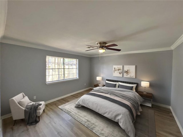 bedroom featuring hardwood / wood-style floors, ceiling fan, and crown molding