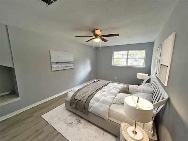 bedroom featuring ceiling fan and wood-type flooring