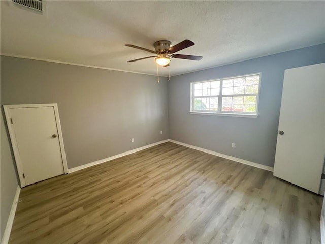 unfurnished bedroom with ornamental molding, ceiling fan, and hardwood / wood-style floors