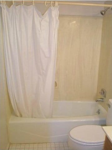 full bathroom with vanity, toilet, and shower / bath combo with shower curtain