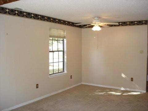 spare room with ceiling fan and a textured ceiling