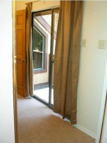 corridor with plenty of natural light and light carpet