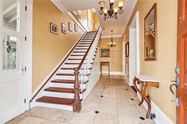 entrance foyer with crown molding, light tile patterned floors, and a notable chandelier