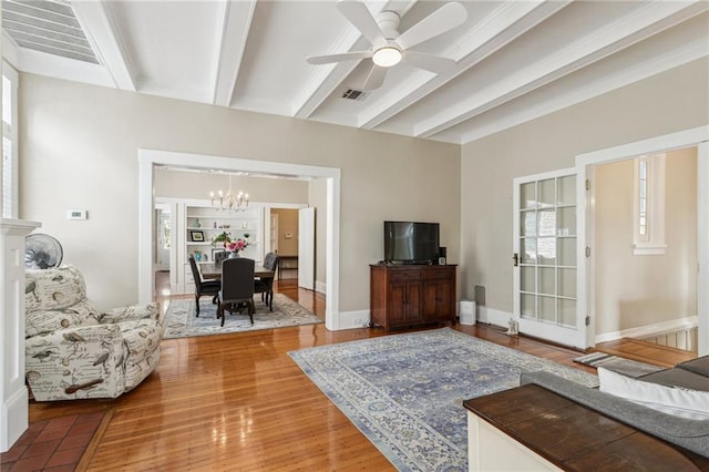 living room with wood-type flooring, beam ceiling, and ceiling fan with notable chandelier