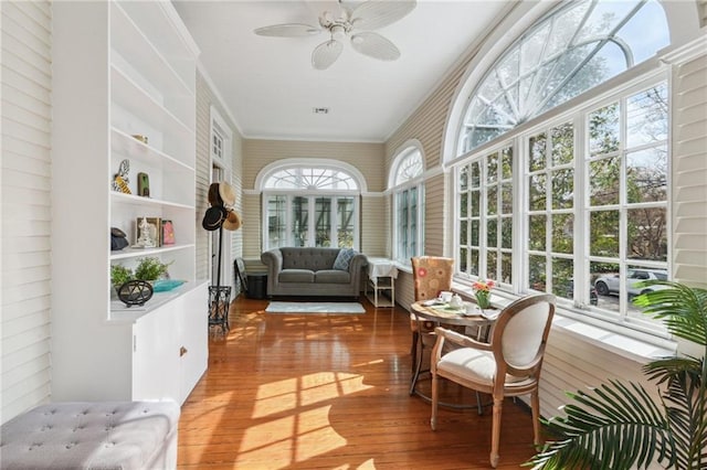 sunroom featuring ceiling fan