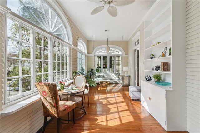 sunroom with a healthy amount of sunlight and ceiling fan