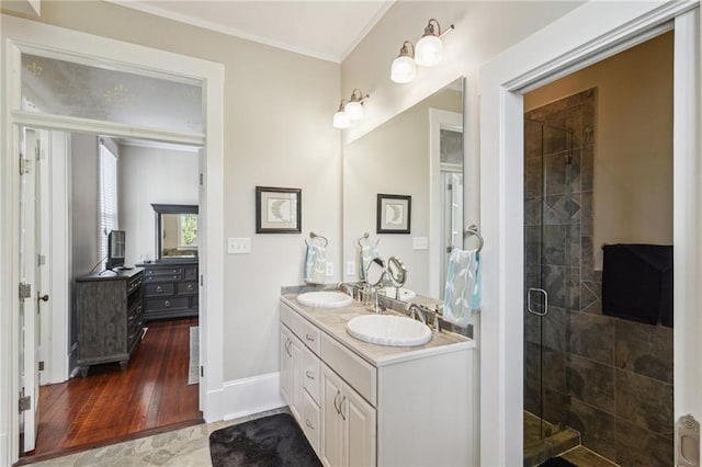 bathroom with vanity, hardwood / wood-style flooring, and a shower with door