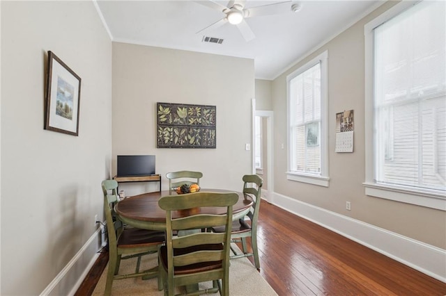 dining space featuring hardwood / wood-style floors, ornamental molding, and ceiling fan