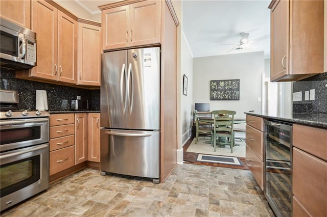 kitchen with wine cooler, tasteful backsplash, stainless steel appliances, and dark stone counters