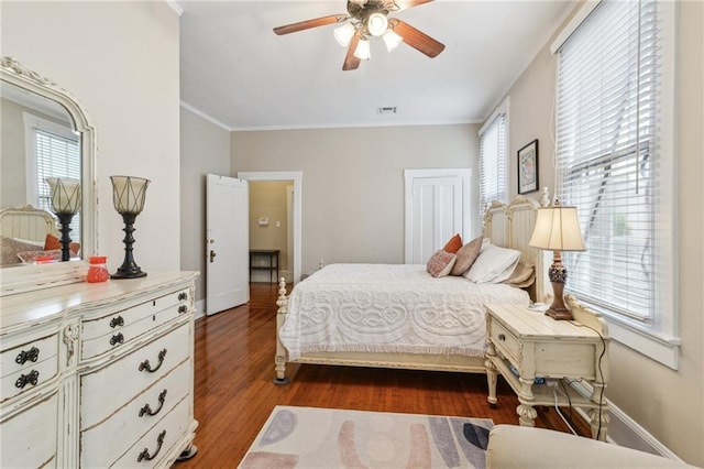 bedroom featuring ornamental molding, dark hardwood / wood-style floors, and ceiling fan