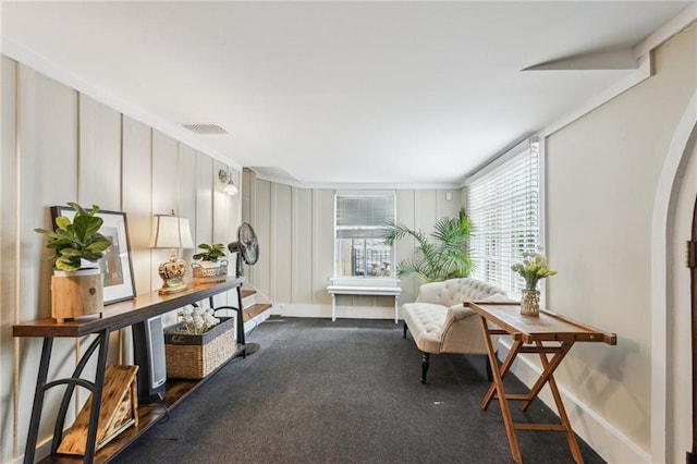 living area with dark carpet