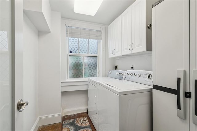 laundry area with cabinets and washer and clothes dryer