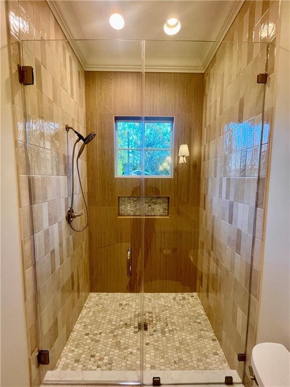 bathroom with an enclosed shower, crown molding, and toilet