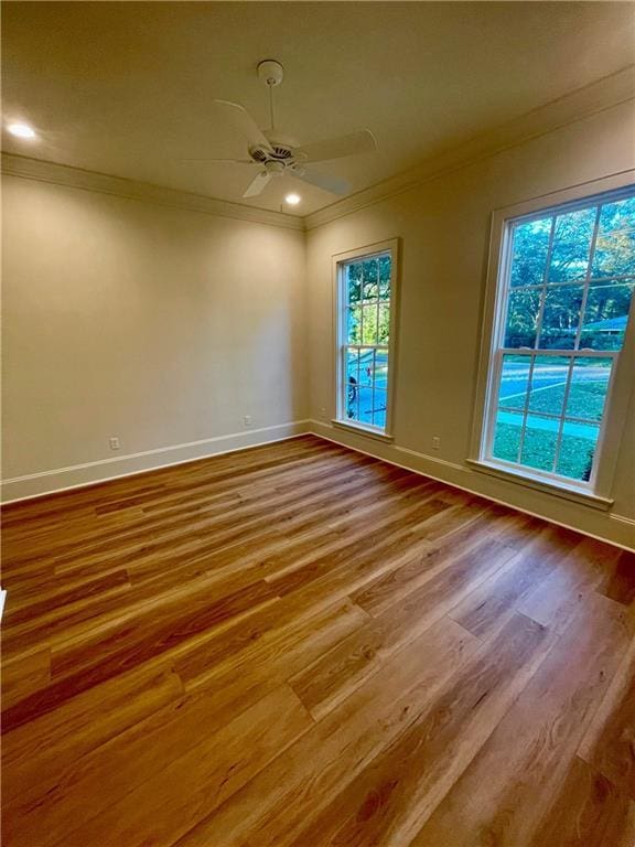 unfurnished room featuring hardwood / wood-style flooring, ornamental molding, and ceiling fan