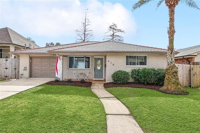 ranch-style home featuring a garage and a front lawn