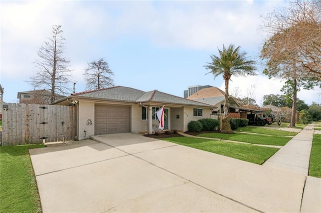 ranch-style home featuring a garage and a front lawn