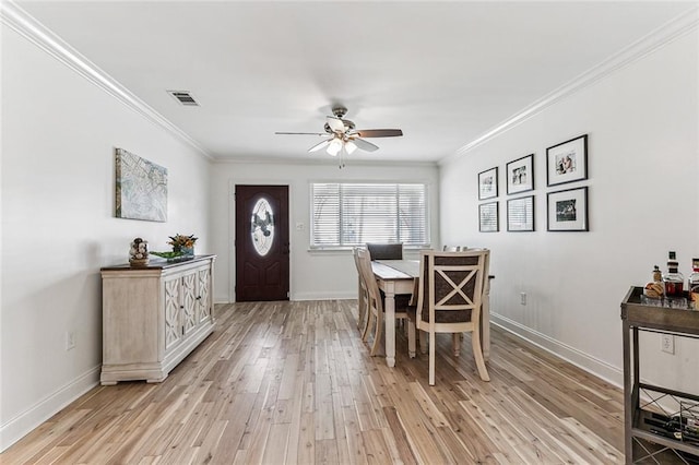 dining space featuring ornamental molding, ceiling fan, and light hardwood / wood-style floors