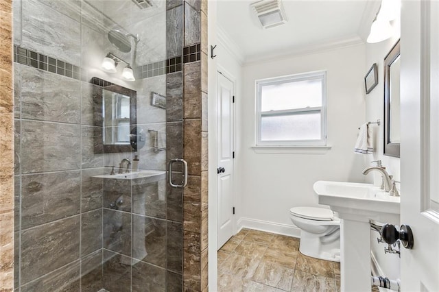 bathroom with crown molding, toilet, and a shower with door