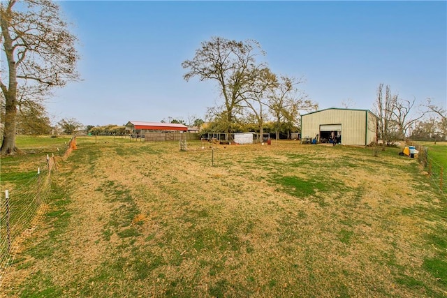 view of yard with a rural view and an outbuilding