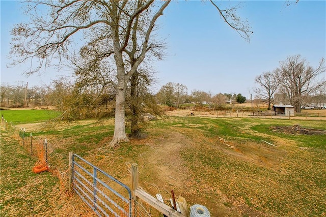 view of yard featuring a rural view and an outdoor structure