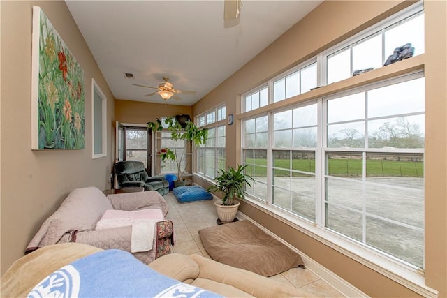 sunroom featuring a healthy amount of sunlight and ceiling fan