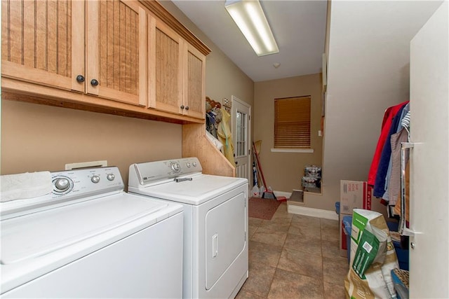 clothes washing area with independent washer and dryer and cabinets