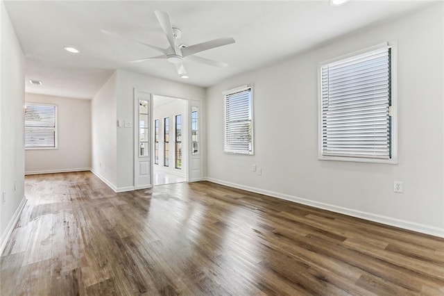 unfurnished room featuring dark wood-type flooring and ceiling fan