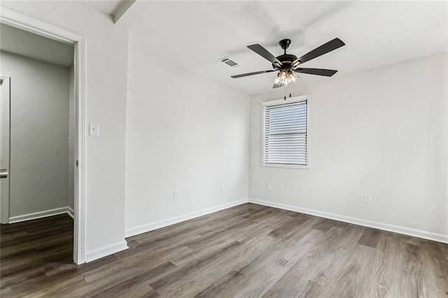 unfurnished room featuring dark wood-type flooring and ceiling fan