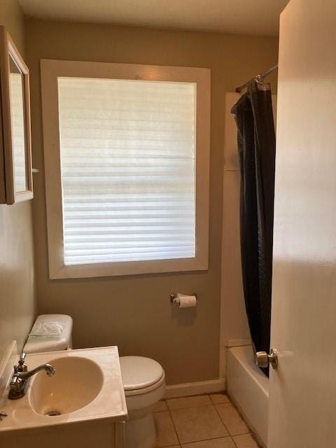 full bathroom featuring tile patterned flooring, sink, toilet, and shower / bath combo with shower curtain