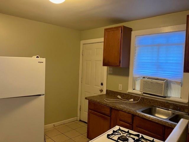 kitchen with cooling unit, sink, light tile patterned flooring, and white refrigerator