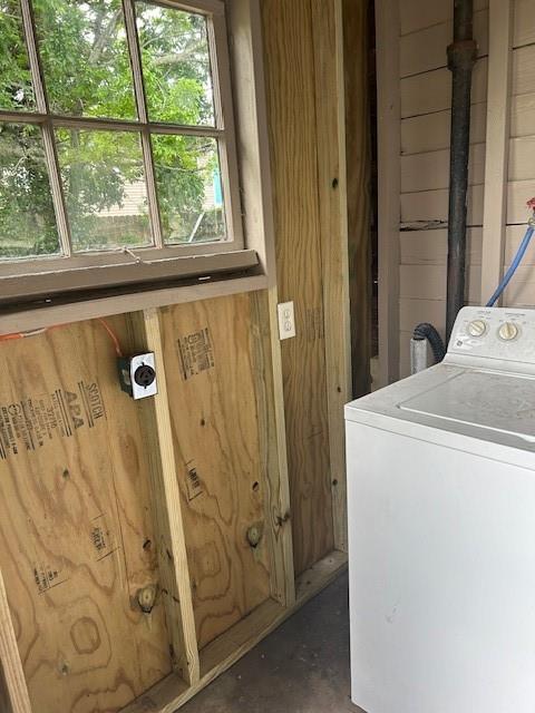 laundry area with washer / clothes dryer and wood walls