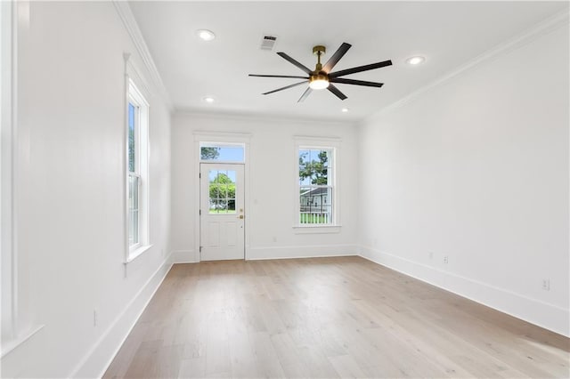 unfurnished room with crown molding, ceiling fan, and light wood-type flooring